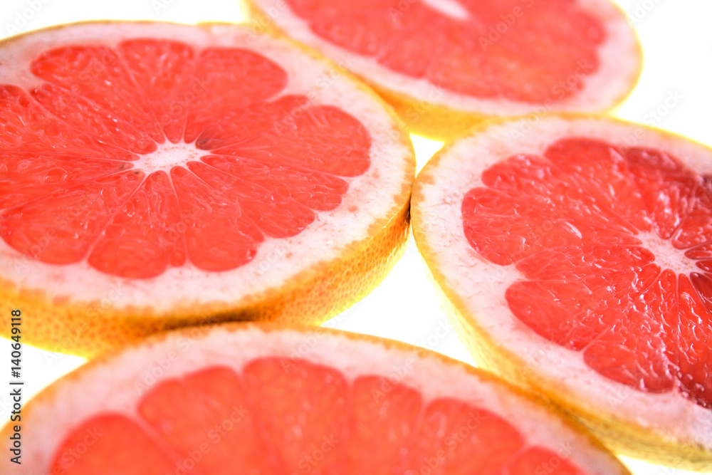 Closeup of sliced grapefruit on white background Closeup of sliced grapefruit on white background