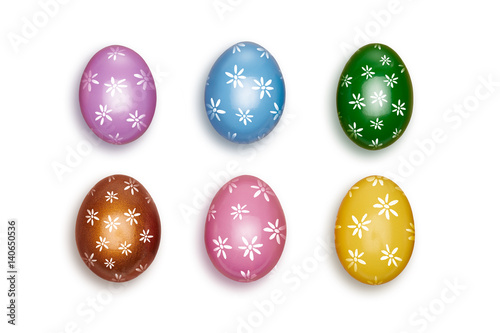 Looking down, vertical vew of Small colorful decorated Easter eggs isolated on a white background.