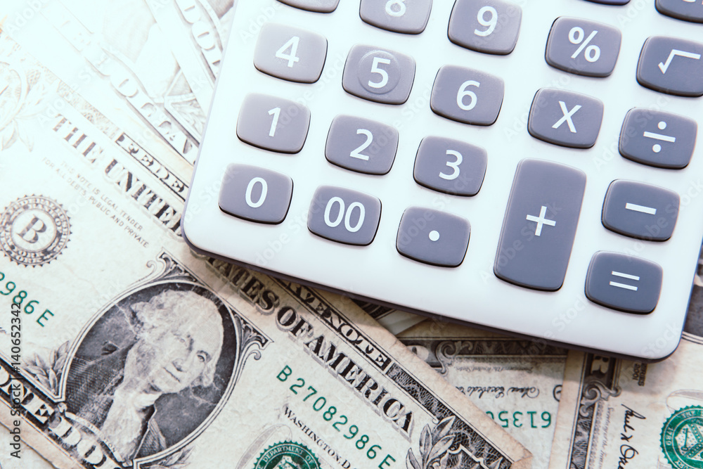 Calculator with american dollars on the wooden table background, finance concept Calculator with american dollars on the wooden table background, finance concept