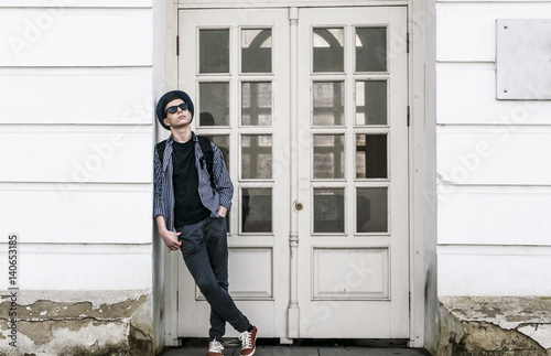 Stylish young man near the doors of the building © Yalana