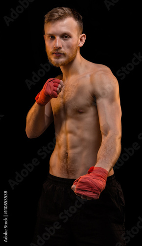 Bearded fighter with boxing bandages