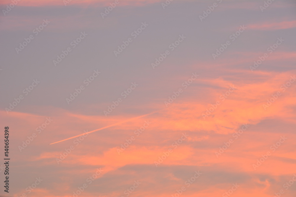 Sky and cloud, clear orange sky with plain white cloud with space for text