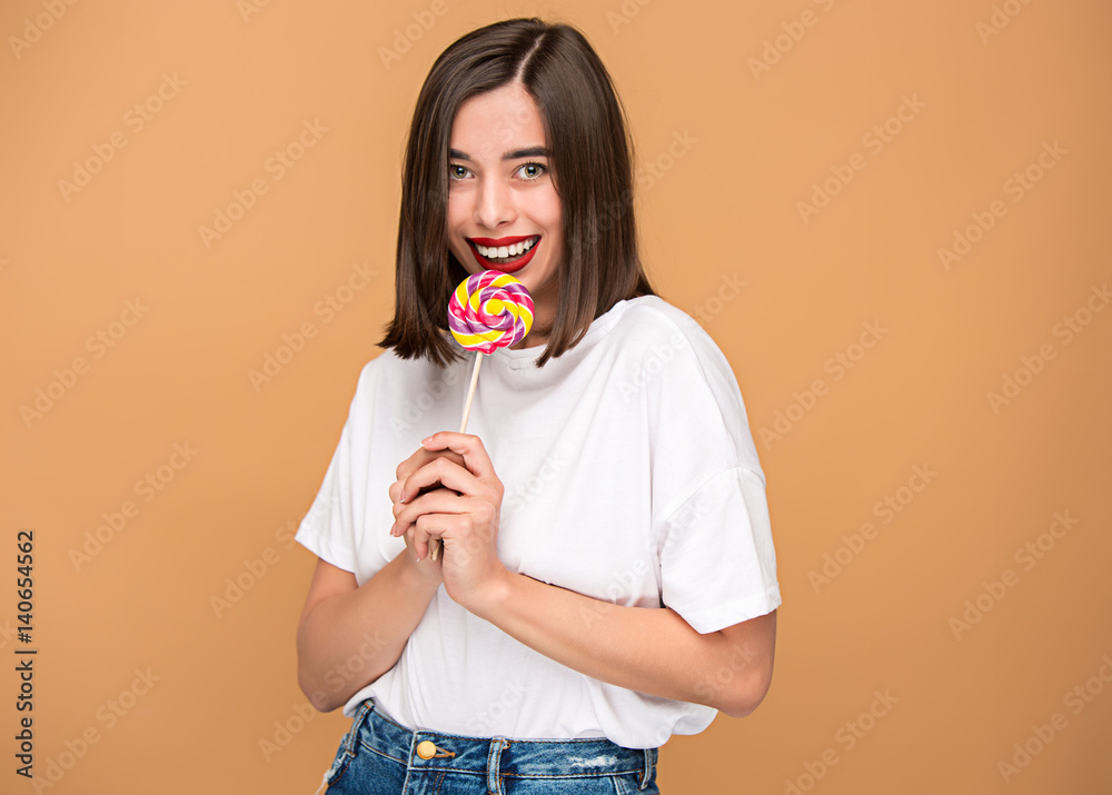 The young woman with colorful lollipop The young woman with colorful lollipop