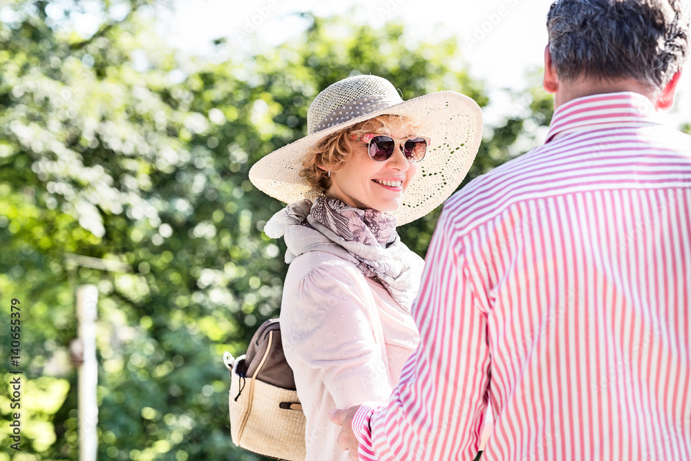 Fototapeta premium Happy middle-aged woman with man in park