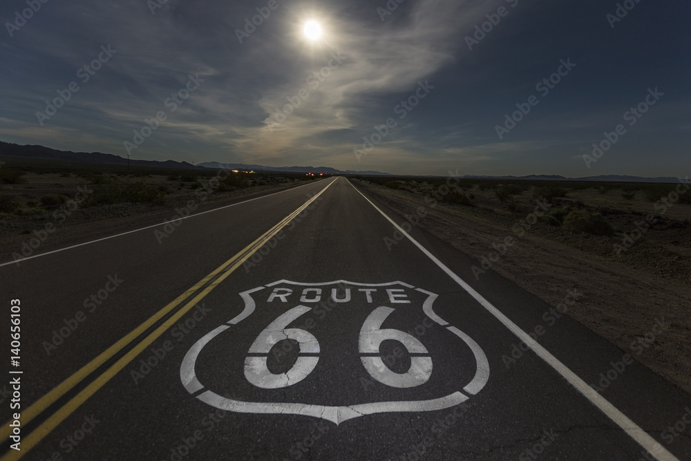 Naklejka premium Full moon over Route 66 in the California Mojave desert. 