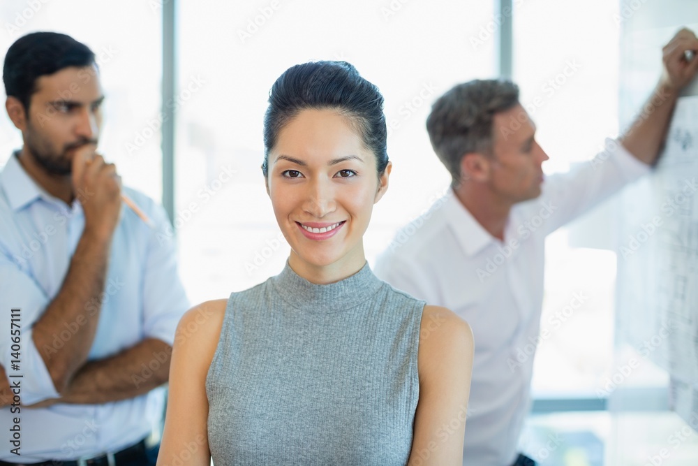 Smiling female architect standing in office Smiling female architect standing in office