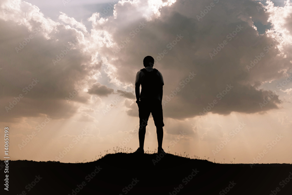 Silhouette of man and sky with sunlight