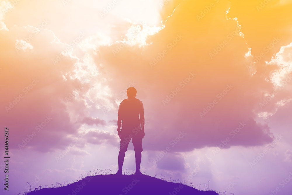 Silhouette of man and sky with sunlight