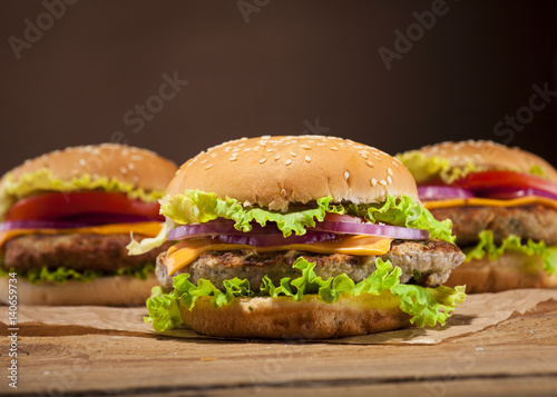Fresh burgers on wooden background