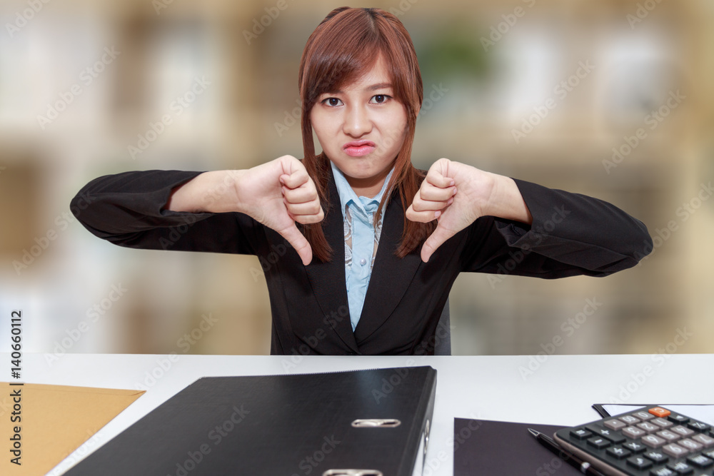 Εκτύπωση καμβά Unhappy business woman with thumb down in office - calculator, file and document on desk