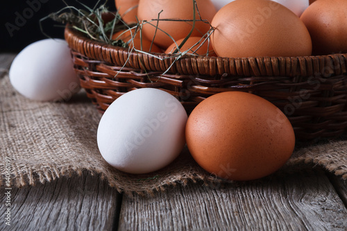 Fresh chicken white and brown eggs on sack closeup, organic farming background