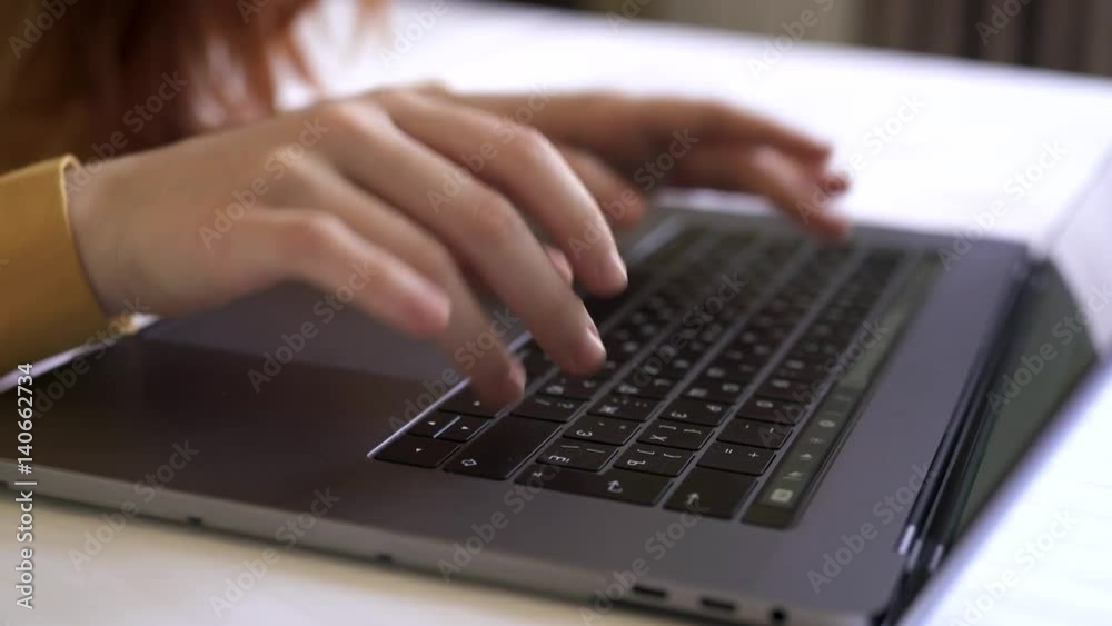 Laptop keyboard view from above female hands
Laptop keyboard view from above female hands