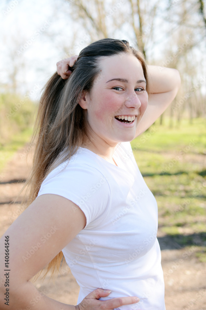 Portrait of happy beautiful young woman enjoying sun light in the park. Portrait of happy beautiful young woman enjoying sun light in the park.