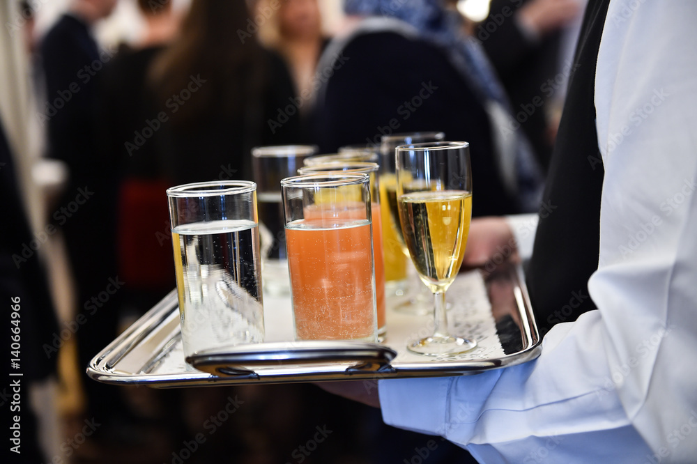 Waiter holding a tray with beverages during cocktail party