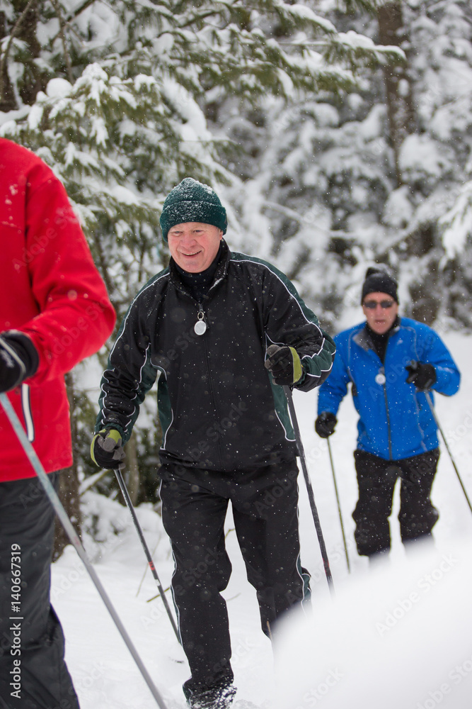 seniors in winter on snow with skis cross-country skiing