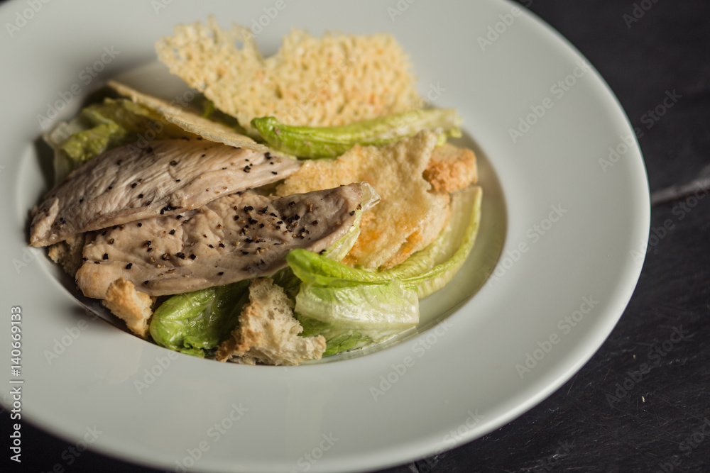 Tasty Caesar salad with chicken. Traditional food. Restaurant