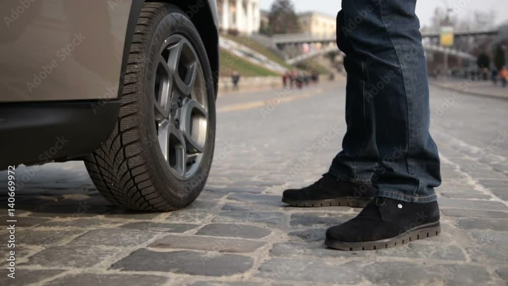 Man helping young woman to get out from the car