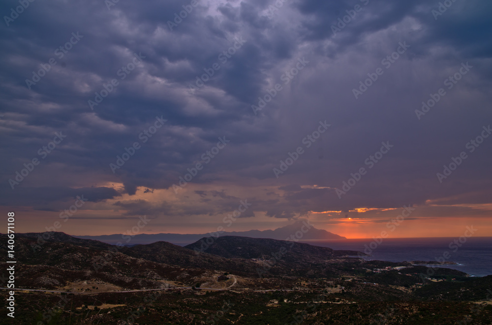Stormy sky and sunrise at holy mountain Athos in Greece