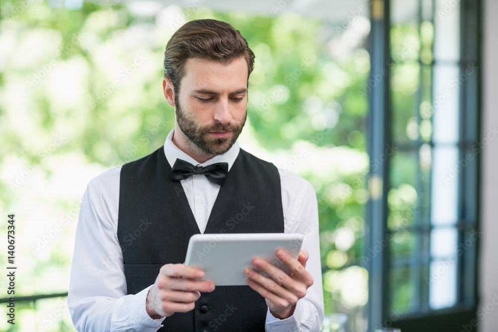 Male waiter using digital tablet Male waiter using digital tablet
