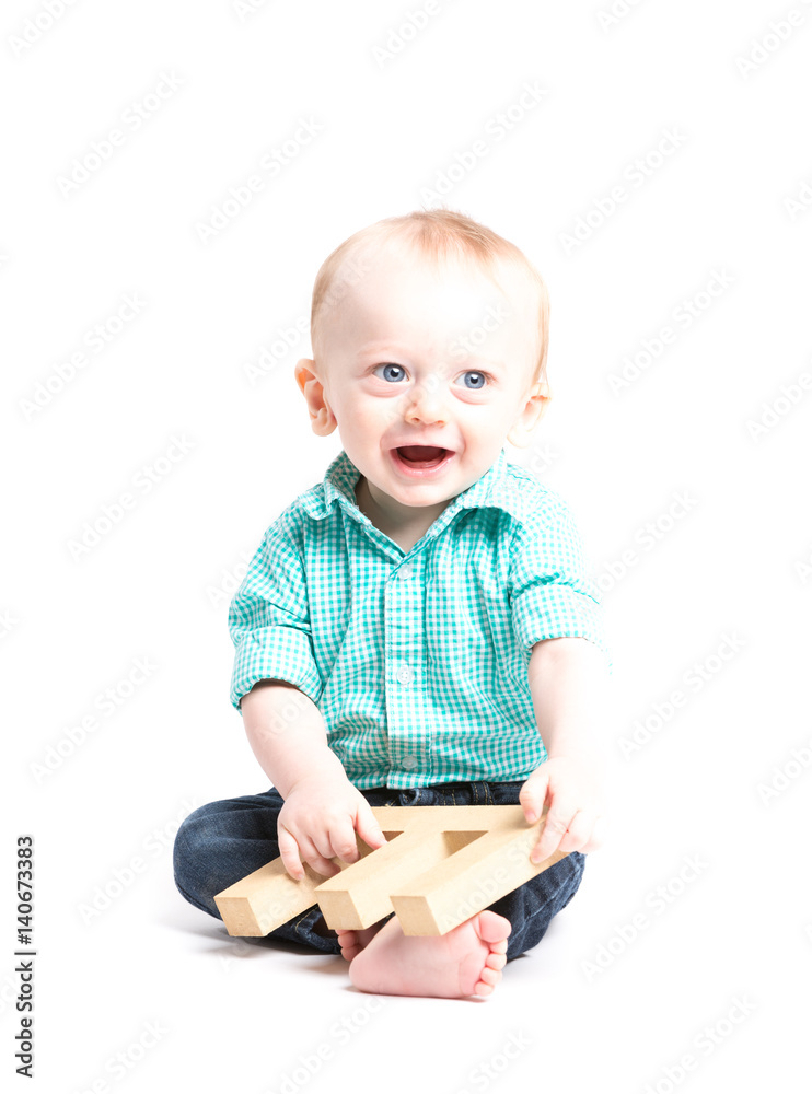 Baby Smiling Sitting Holding Letter E. a 6 month old baby sitting in a ...
