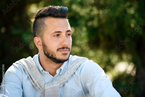 portrait of a young man, hipster, with a  black beard