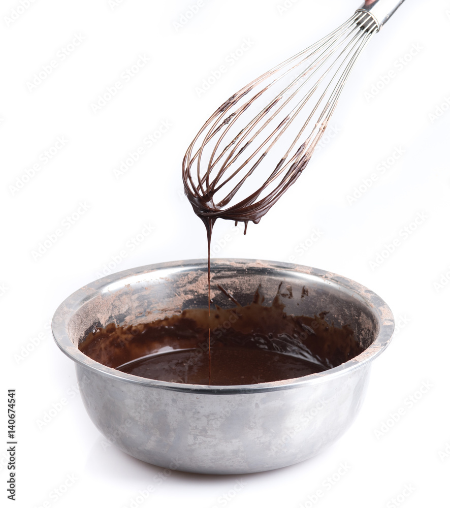 Whisk with bowl and chocolate dessert for cooking on white