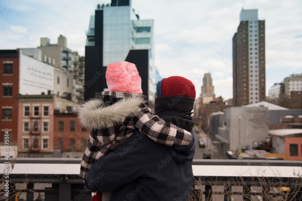 Father and Daughter standing on High Line look at New York City Cityscape 