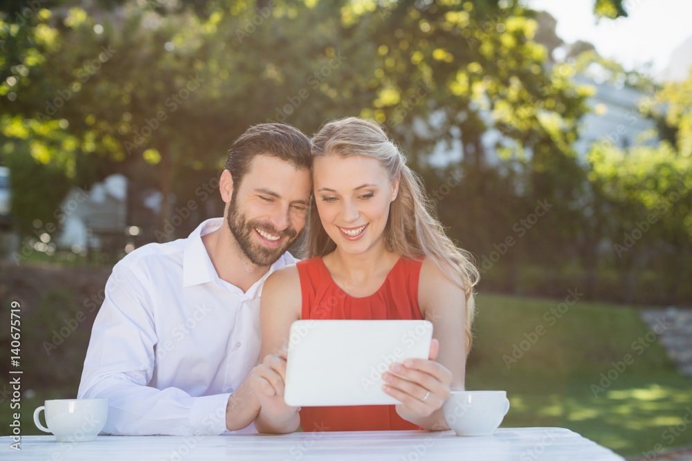 Couple using digital tablet in a restaurant Couple using digital tablet in a restaurant