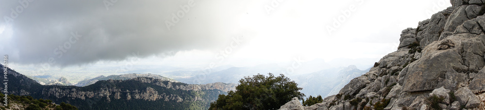 Fototapeta premium Rocky mountains and a clouded sky