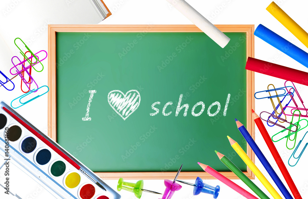 Small school desk with various school supplies close-up isolated on white Small school desk with various school supplies close-up isolated on white