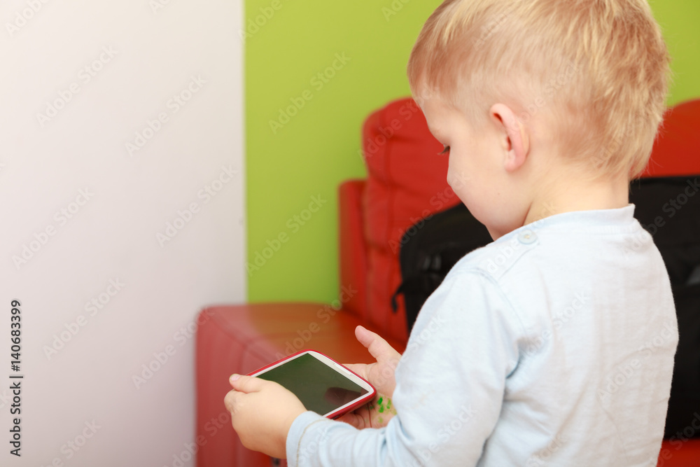 Little boy using smartphone playing games Little boy using smartphone playing games