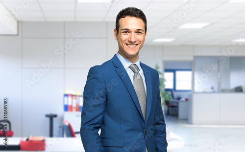Smiling businessman in his office