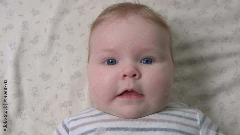 Cute baby sneezes and smiles at the camera Cute baby sneezes and smiles at the camera