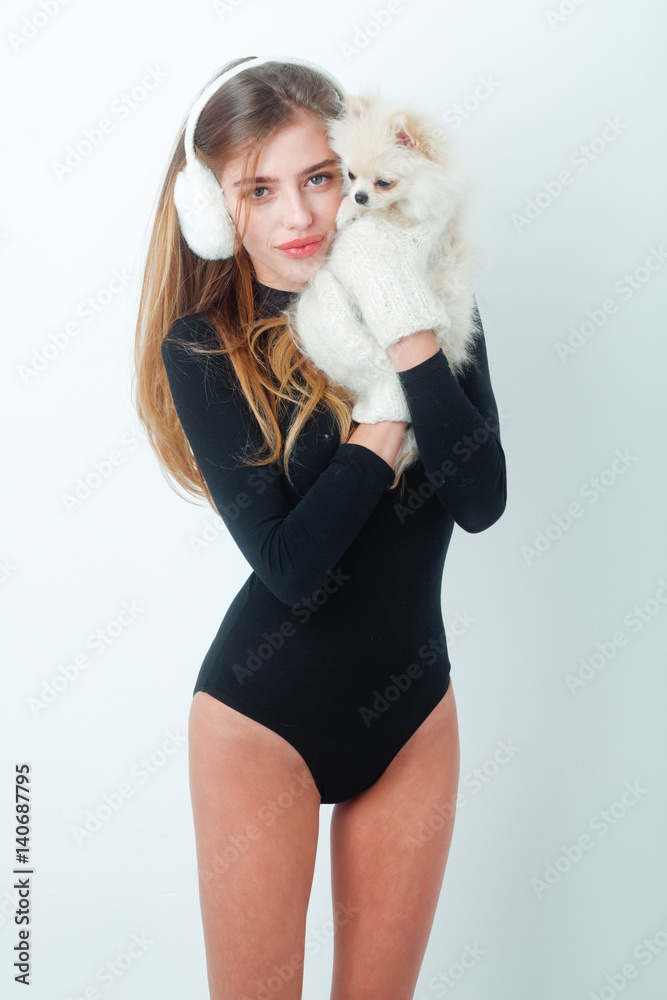 sexy pretty happy girl with small pomeranian dog in earmuffs Stock Photo |  Adobe Stock