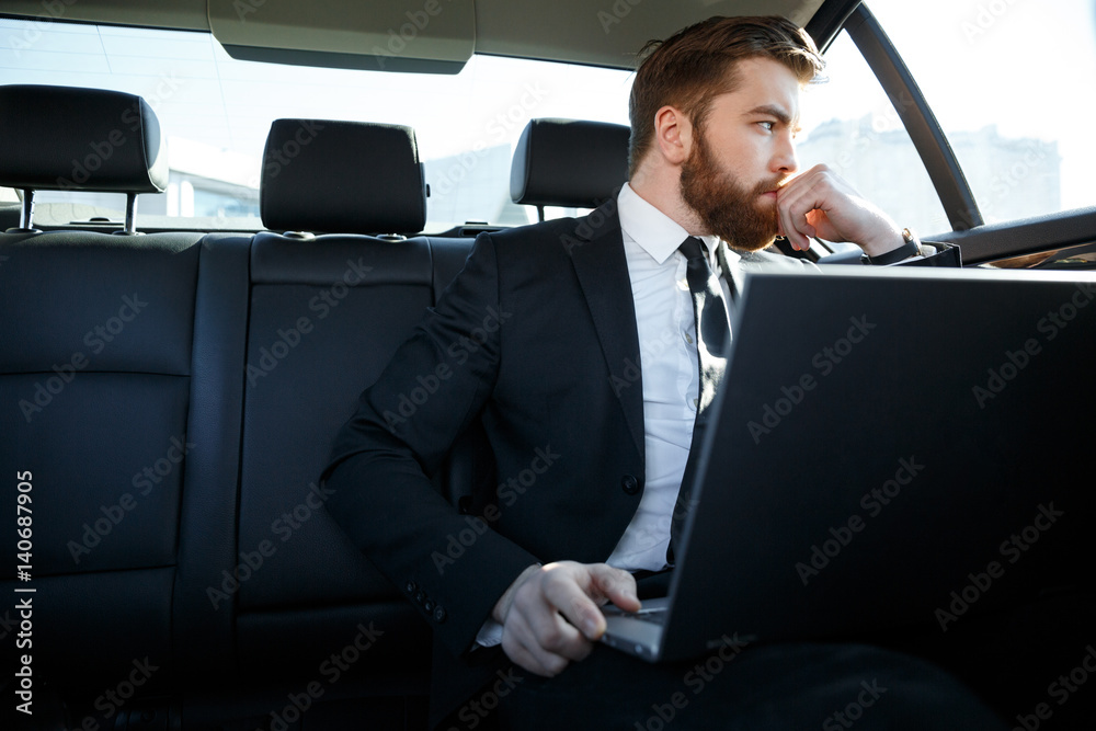 Pensive business man with laptop computer