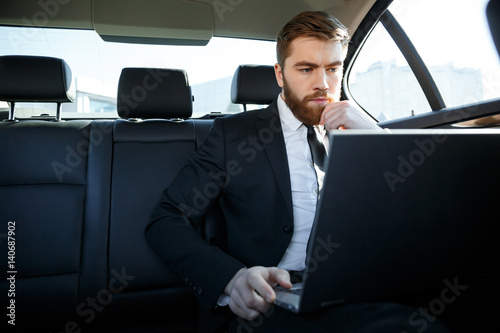 Calm business man using laptop computer © Drobot Dean