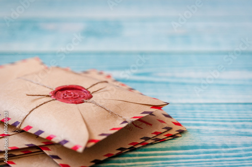 Old vintage retro envelopes with a wax stamp on old blue wooden table