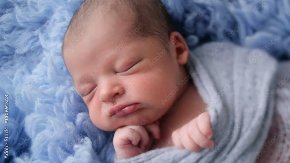 newborn baby lying in blue fur wrapped in diaper photo shoot newborn baby lying in blue fur wrapped in diaper photo shoot