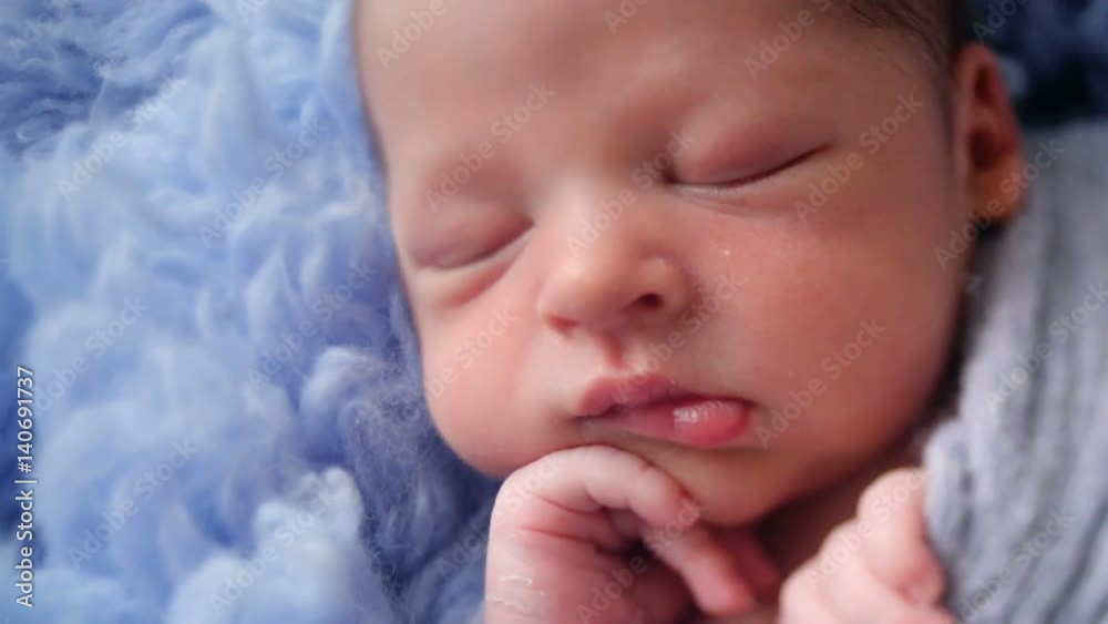 newborn baby lying in blue fur wrapped in diaper photo shoot newborn baby lying in blue fur wrapped in diaper photo shoot