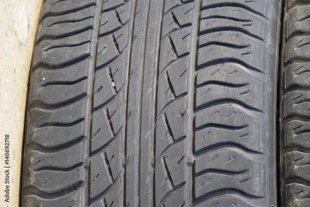 The background of the tread pattern of the car wheel. Rubber tir