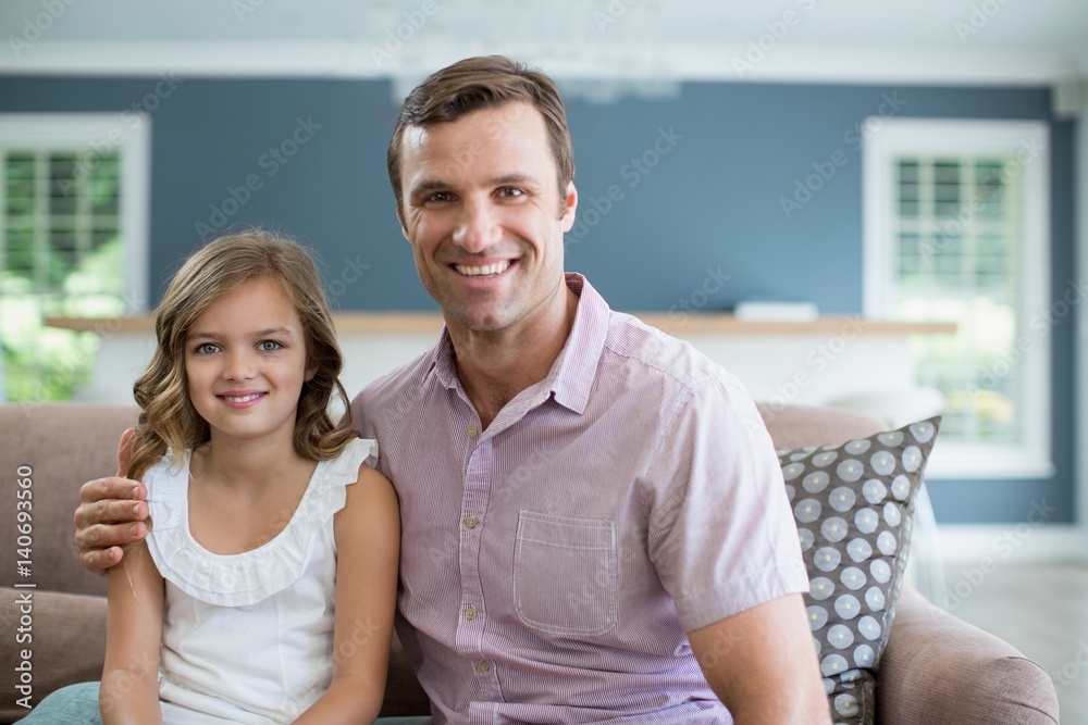 Smiling father and daughter sitting on sofa Smiling father and daughter sitting on sofa