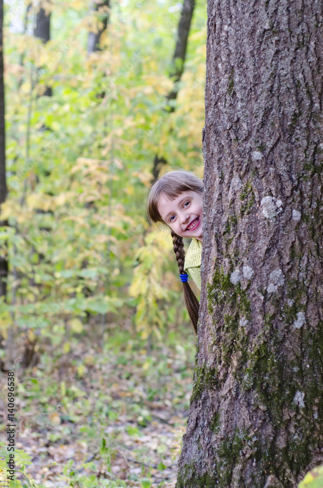 Little girl is walking in the autumn park Little girl is walking in the autumn park