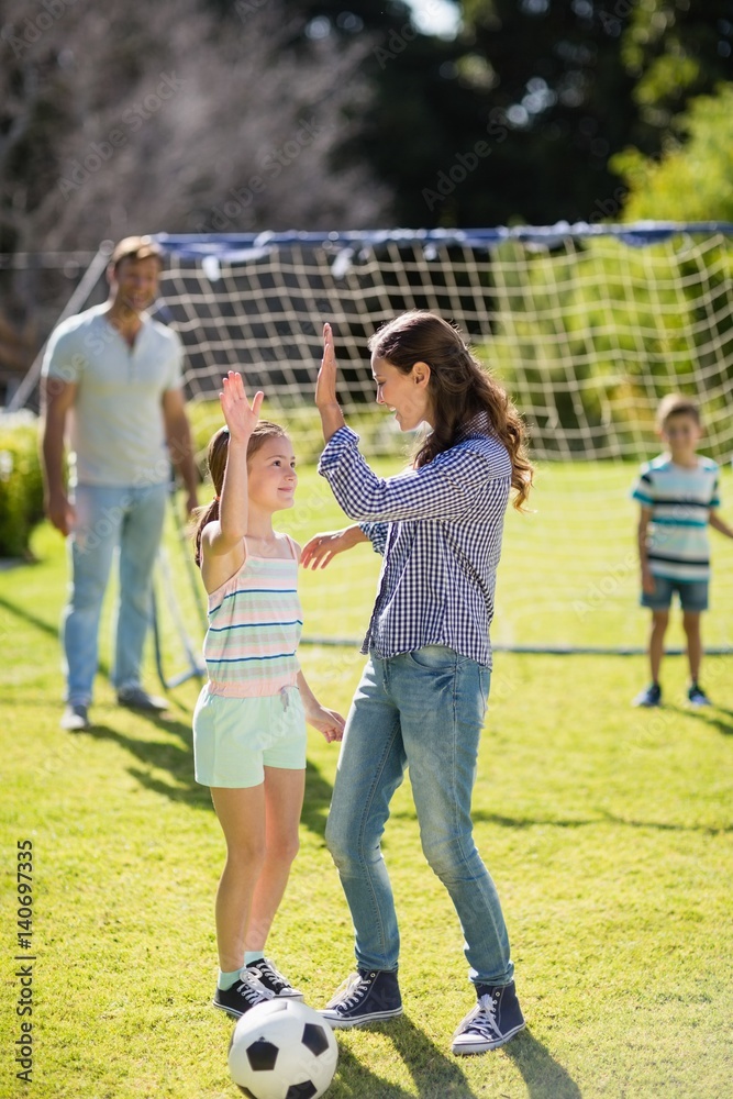 Fototapeta premium Mother and daughter playing football