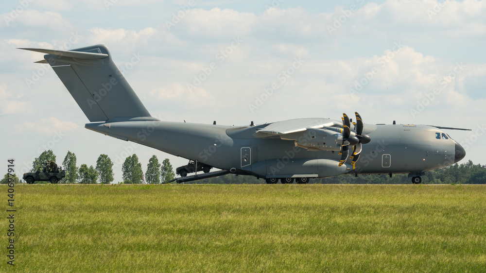 Vehicles driving out of a cargo aircraft Vehicles driving out of a cargo aircraft