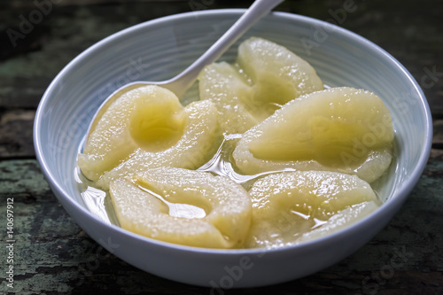 Pears in syrup in blue bowl 