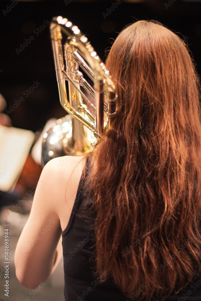 Young woman playing trombone Stock Photo