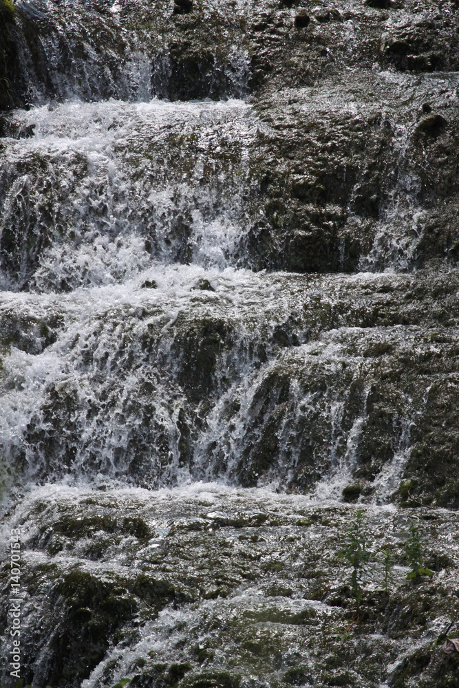 Streams of clear water on stone waterfall ledges. Streams of clear water on stone waterfall ledges.
