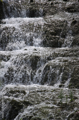 Streams of clear water on stone waterfall ledges.