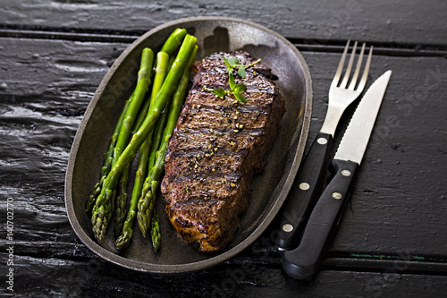 Steak with green asparagus photo