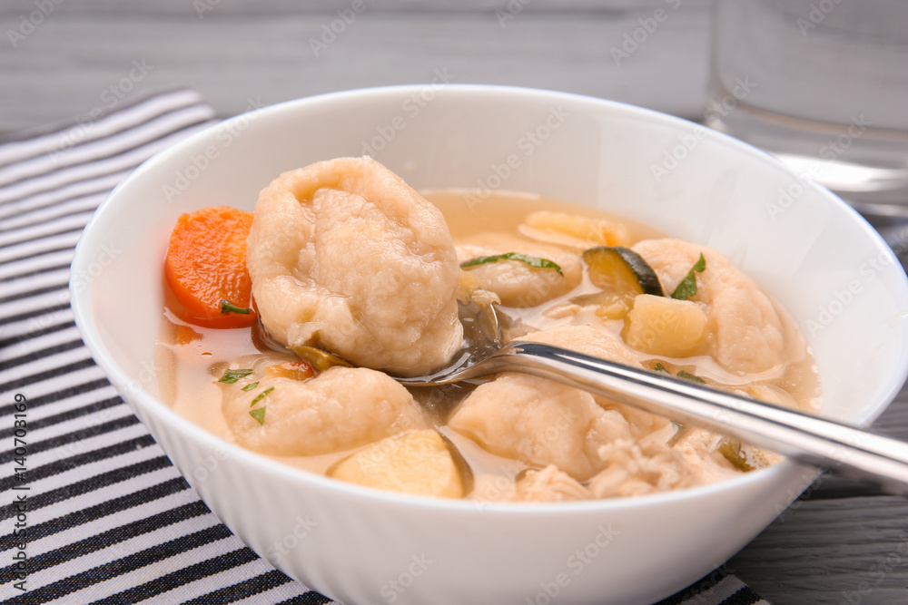 Portion of delicious chicken and dumplings on dining table Portion of delicious chicken and dumplings on dining table